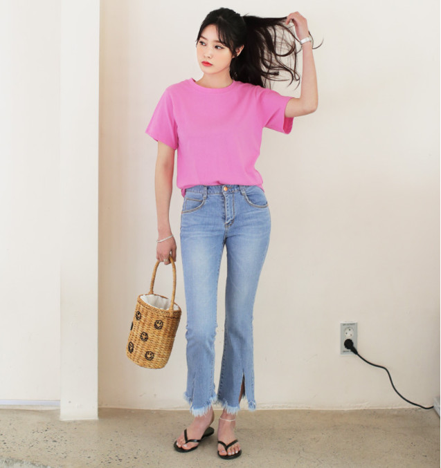 Một cô gái năng động mặc áo phông oversize và quần jeans xắn gấu, chiếc quần jeans này hoàn toàn có thể được tái chế thành một chiếc váy cá tính.