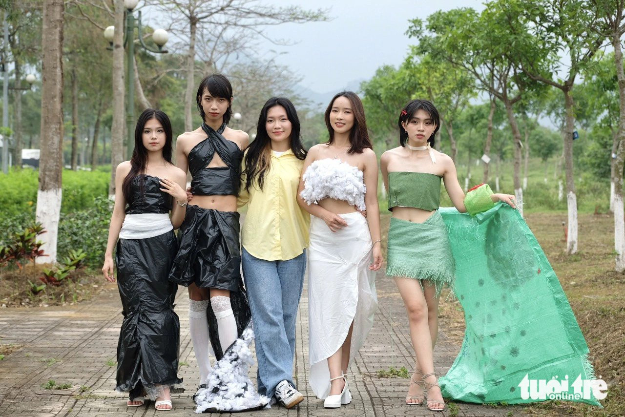 Nguyễn Kiều Trang (giữa) chụp ảnh cùng bốn người mẫu mặc trang phục do mình thiết kế, trình diễn tại chương trình